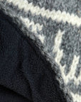 Close-up of a textured fabric with a patterned edge